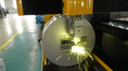 Load image into Gallery viewer, CNC Tube Cutting machine cutting metal with sparks in a factory setting